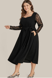 Black plus size dress with scalloped length and lace sleeves