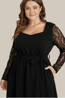 Black plus size dress with scalloped length and lace sleeves