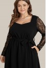 Black plus size dress with scalloped length and lace sleeves
