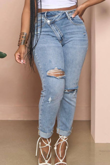 Light modern plus size jeans with a slight rip and diagonal zip