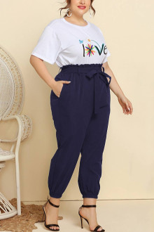 Plus size set of pants and white blouse with a print