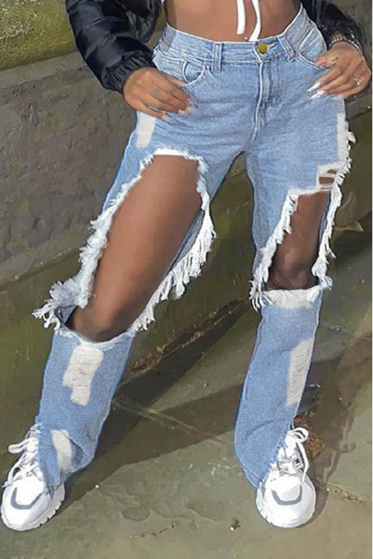 Light jeans with torn and cut-out elements on the knees