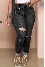 Modern black Plus size jeans with a slight rip and diagonal zip