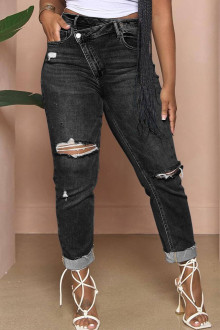 Modern black Plus size jeans with a slight rip and diagonal zip