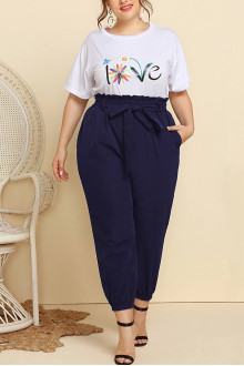 Plus size set of pants and white blouse with a print