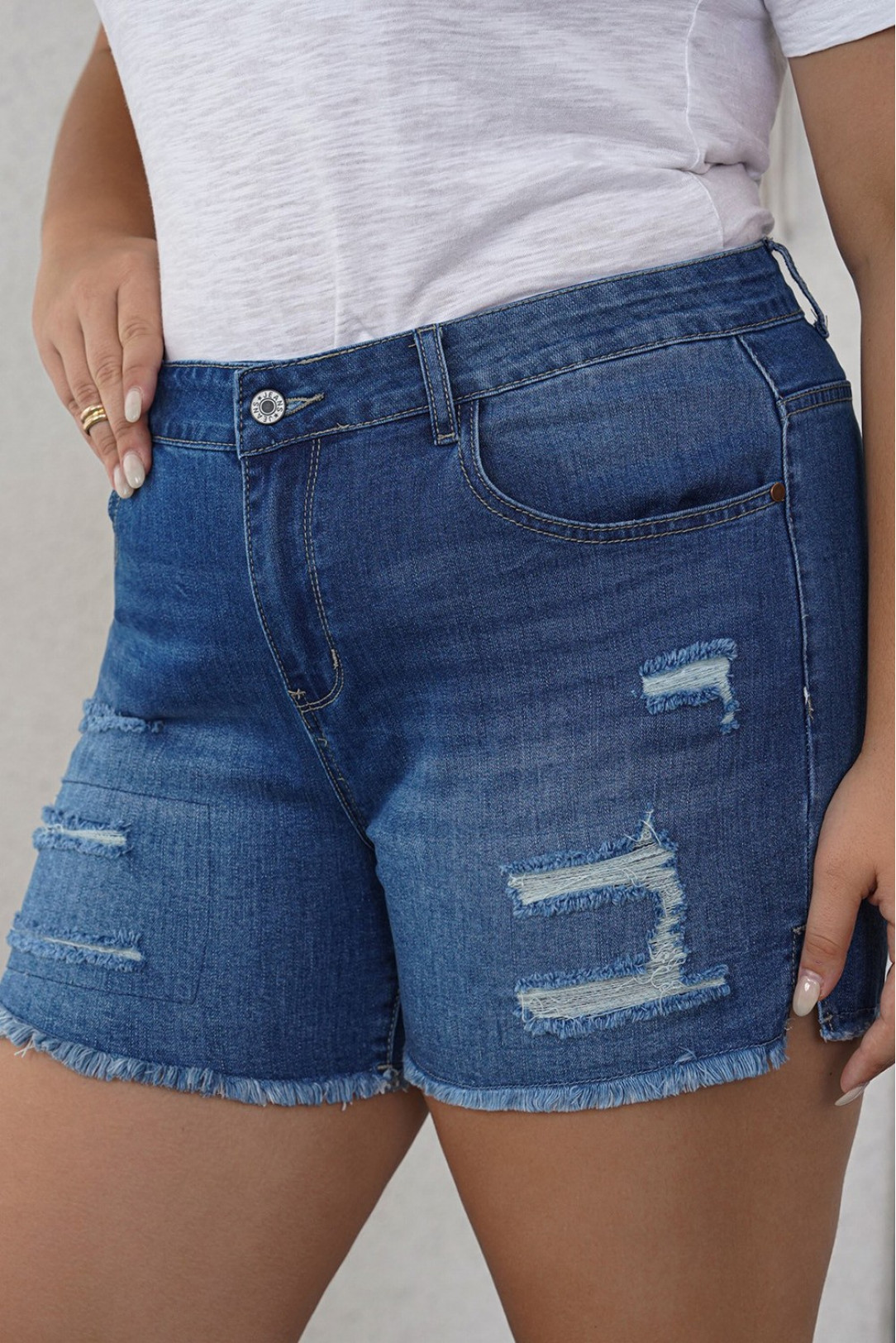 Plus size denim shorts with torn and internal patches 